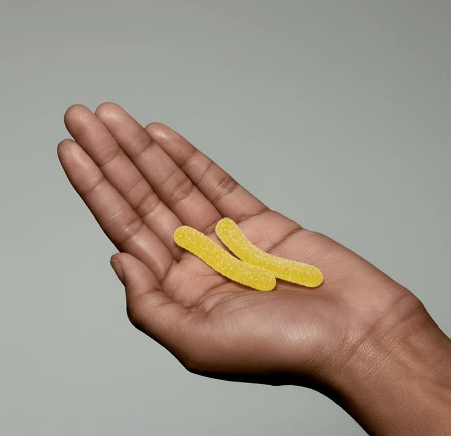 Hand holding Sperm Worms Gummy